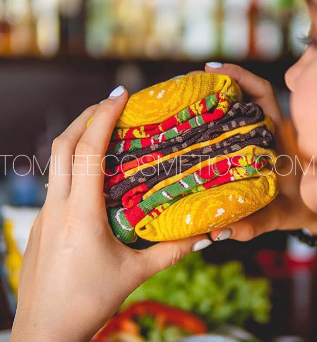 a person holding a hot dog in a bun 