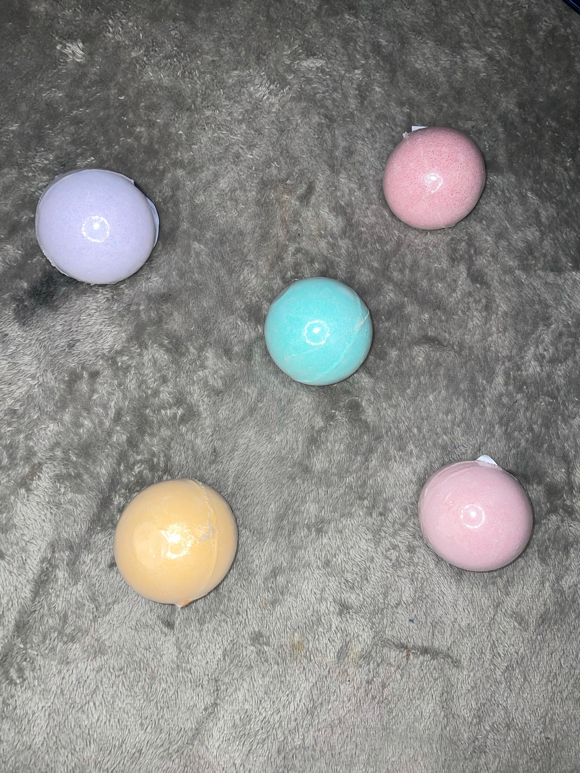 a group of different colored balls on the ground 
